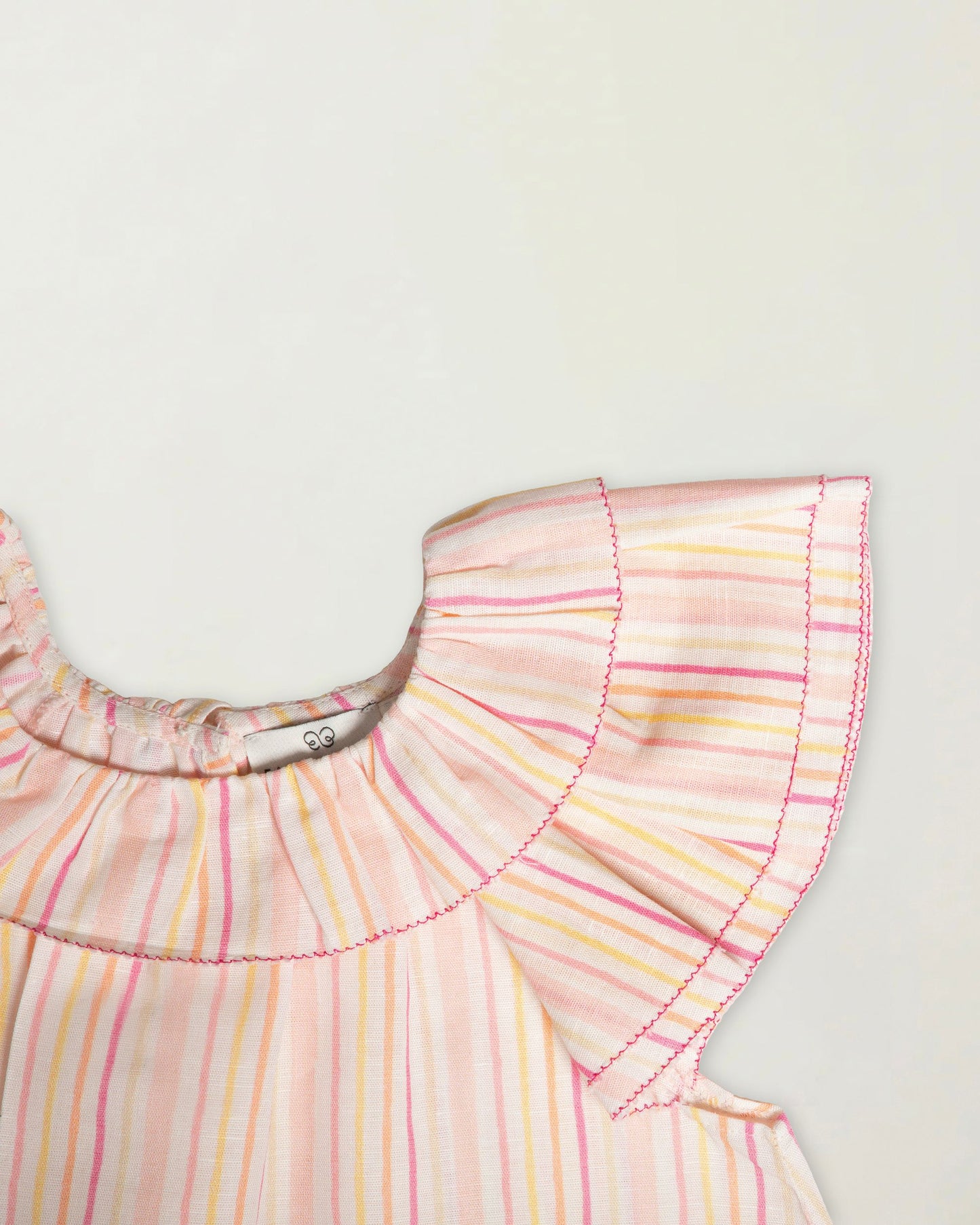 Early Sunday, Lola Blouse in Pink Stripes color, made from printed 70% cotton 30% linen fabric, featuring Ruffled neckline, flutter sleeves with contrast detailing, and gentle gathers for a sweet silhouette, shown in a closeup flat-lay view