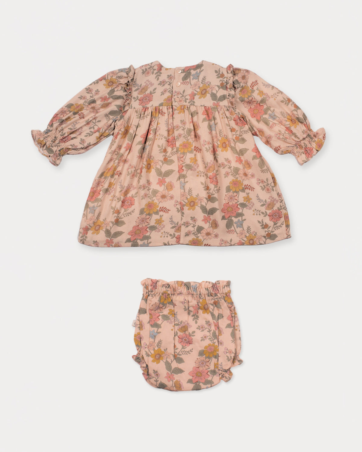 Early Sunday, Lottie Baby Dress & Bloomer Set in Bloom, made from Printed Viscose Twill fabric, featuring a frilly neckline & squared frills around the chest, shown in a back flat-lay view