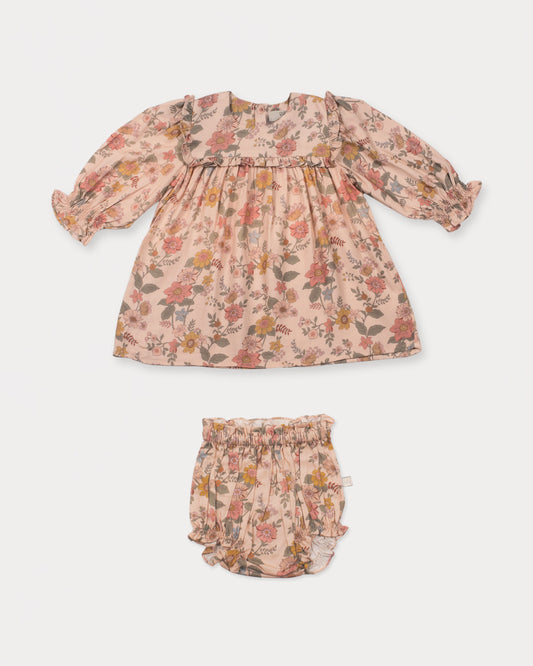Early Sunday, Lottie Baby Dress & Bloomer Set in Bloom, made from Printed Viscose Twill fabric, featuring a frilly neckline & squared frills around the chest, shown in a front flat-lay view