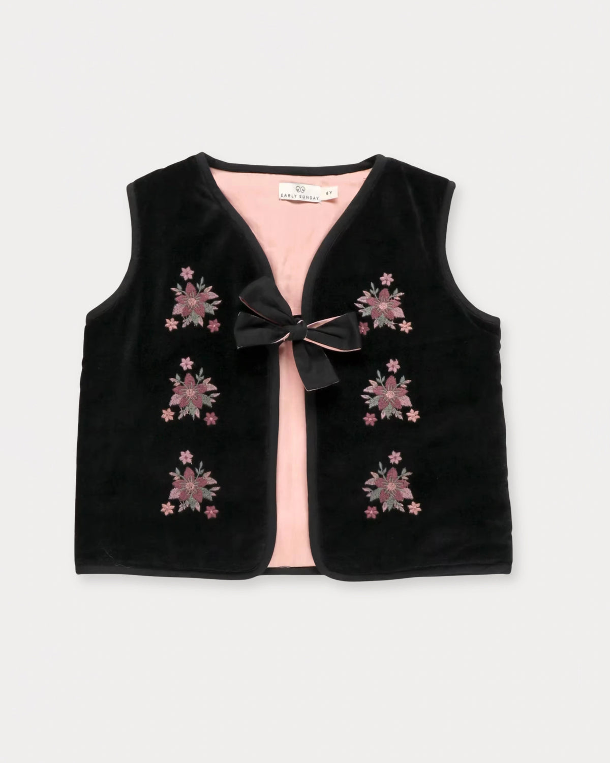 Early Sunday, Lou Vest jacket in Black, made from Cotton Velvet Velour's fabric, featuring sleeveless quilted silhouette with tie-up bow and floral embroidery, shown in a front flat-lay view