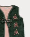 Early Sunday, Lou Vest jacket in Forest Green, made from Cotton Velvet Velour's fabric, featuring sleeveless quilted silhouette with tie-up bow and floral embroidery, shown in a closeup flat-lay view
