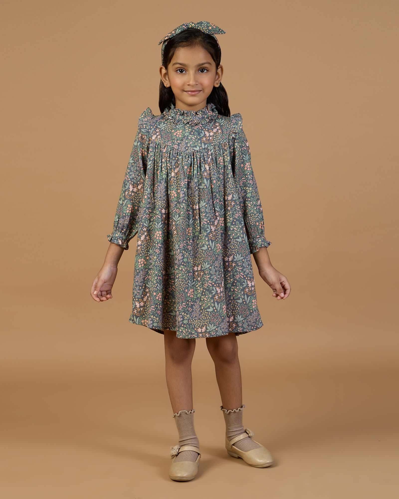 Early Sunday, Louise Dress in Autumn Garden Greyish Blue, made from Printed Cotton Satin fabric, featuring classic silhouette with a charming print, shown in a front view of a model wearing it in a studio setting