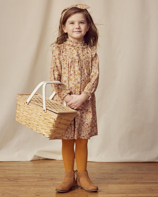 Early Sunday, Louise Dress in Garden Flowers Dusty Pink, made from Printed Cotton Satin fabric, featuring classic silhouette with a charming print, shown in a front view of model wearing it
