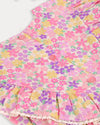 Early Sunday, Lucy Baby Bubble Romper in Emma Floral Purple color, made from 100% Organic Cotton 60s Cambric fabric, featuring a floral print with lace borders, shown in a closeup flat-lay view