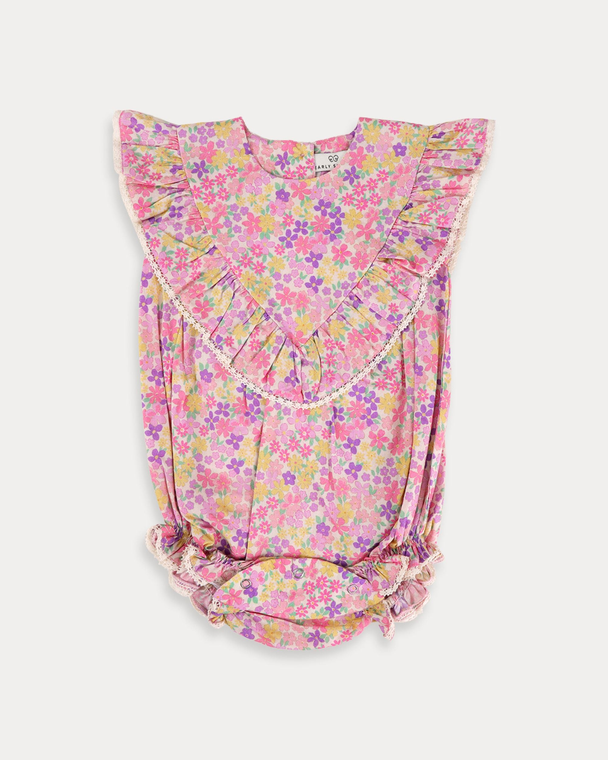 Early Sunday, Lucy Baby Bubble Romper in Emma Floral Purple color, made from 100% Organic Cotton 60s Cambric fabric, featuring a floral print with lace borders, shown in a front flat-lay view