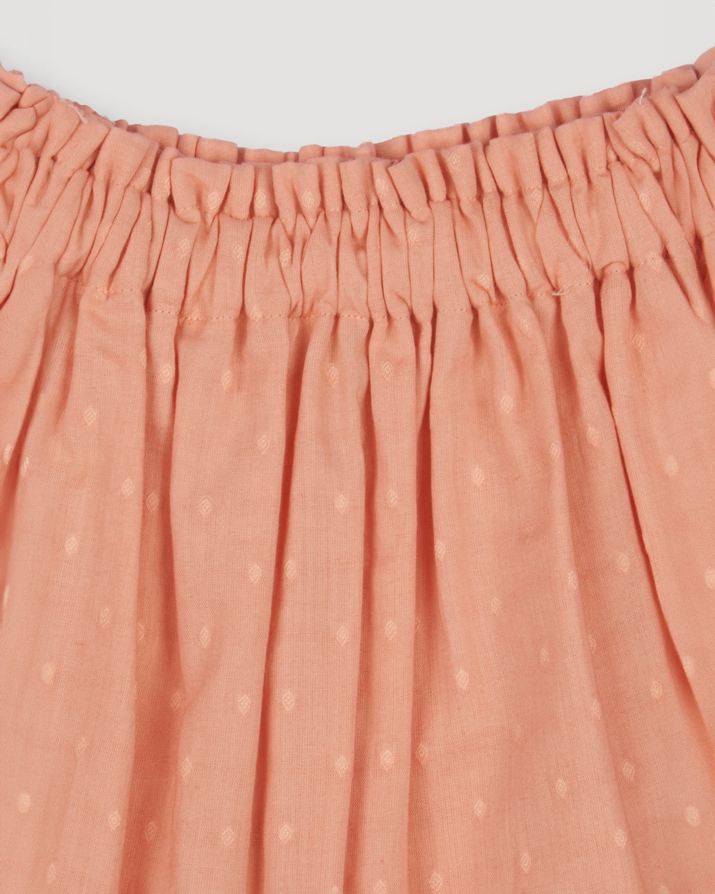 Early Sunday, Luna Skirt in Strawberry color, made from Cotton Dobby Swiss Dots fabric, featuring flattering silhouette with an easy fit, combining style and comfort, shown in a close-up of print