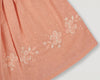 Early Sunday, Luna Skirt in Strawberry color, made from Cotton Dobby Swiss Dots fabric, featuring flattering silhouette with an easy fit, shown in a closeup flat-lay view