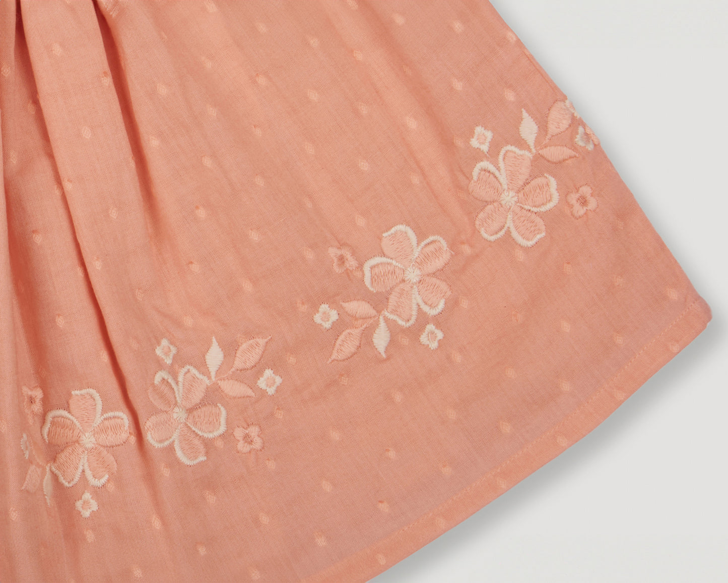 Early Sunday, Luna Skirt in Strawberry color, made from Cotton Dobby Swiss Dots fabric, featuring flattering silhouette with an easy fit, shown in a closeup flat-lay view