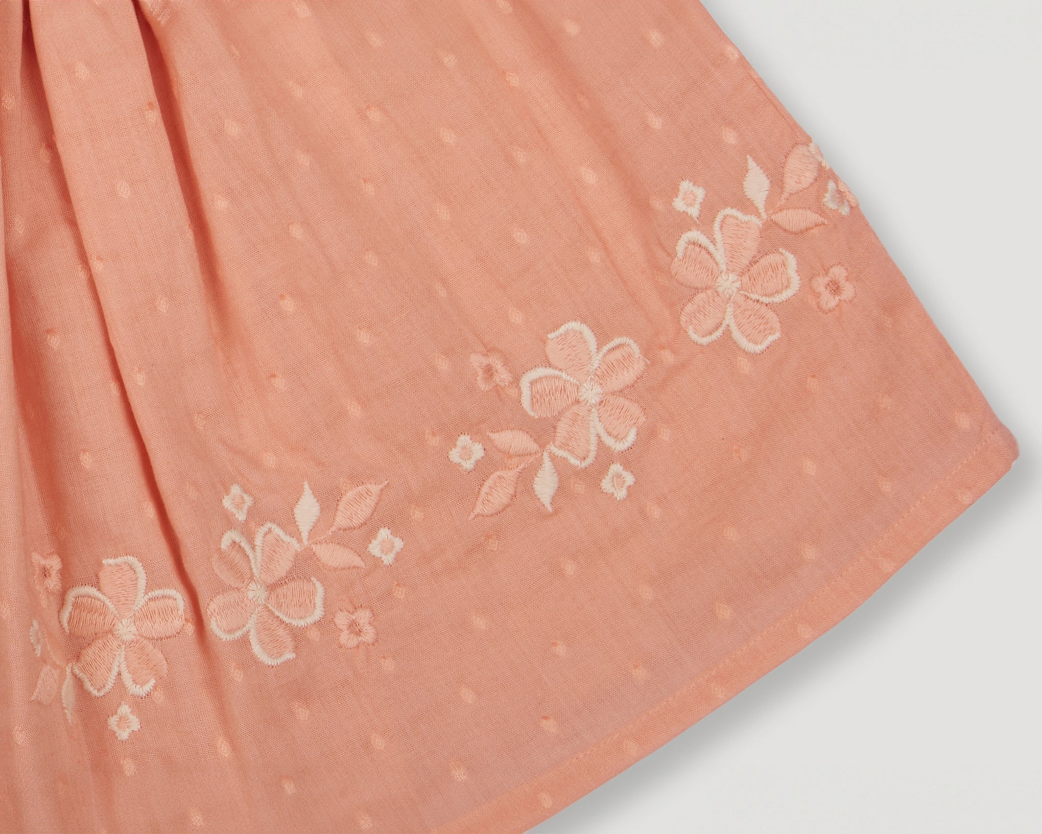 Early Sunday, Luna Skirt in Strawberry color, made from Cotton Dobby Swiss Dots fabric, featuring flattering silhouette with an easy fit, shown in a closeup flat-lay view