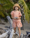 Early Sunday, Luna Skirt in Strawberry color, made from Cotton Dobby Swiss Dots fabric, featuring flattering silhouette with an easy fit, shown in a front view of model wearing it