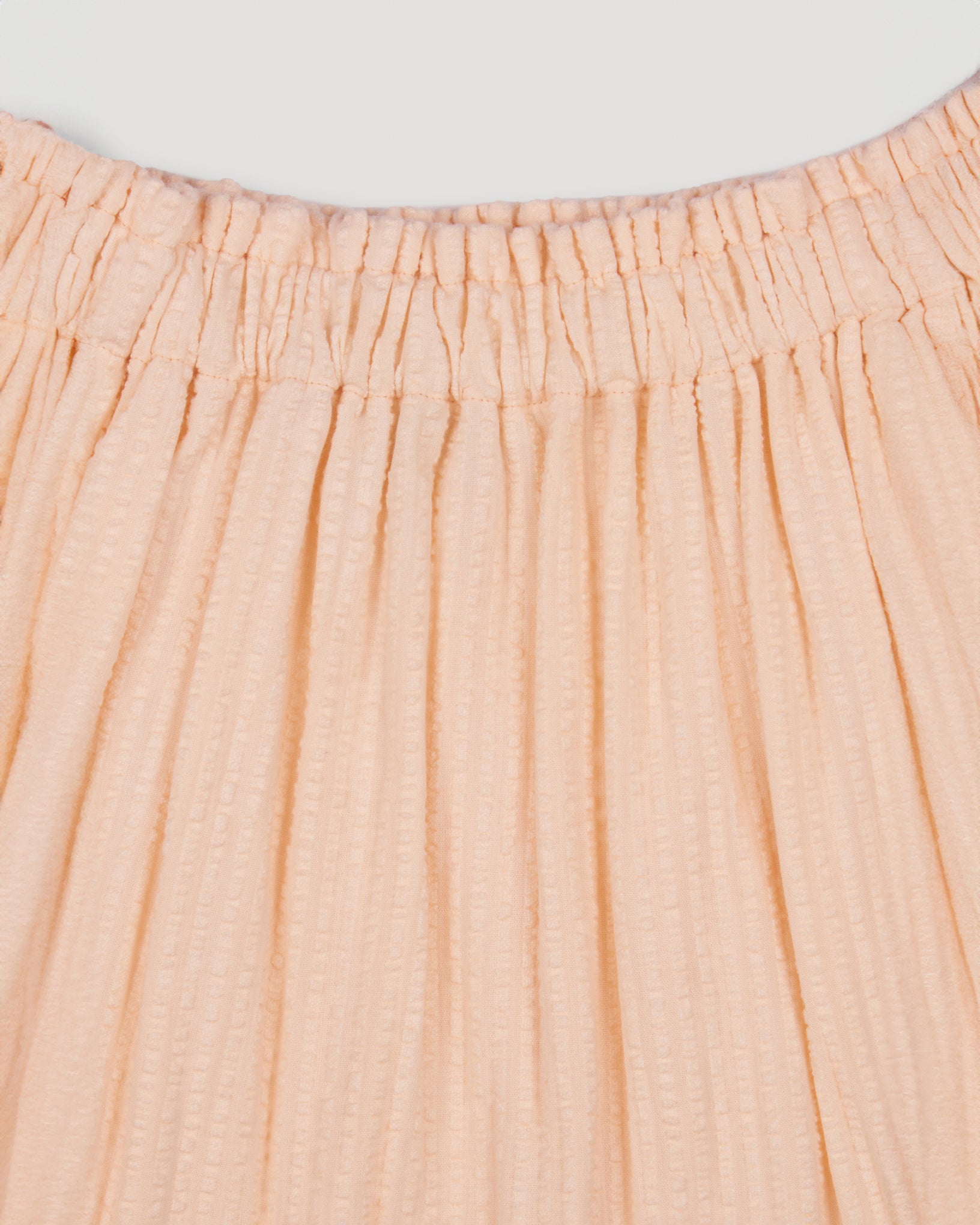 Early Sunday, Luna Skirt in Warm Sand color, made from Cotton Seersucker fabric, featuring flattering silhouette with an easy fit, combining style and comfort, shown in a close-up of print
