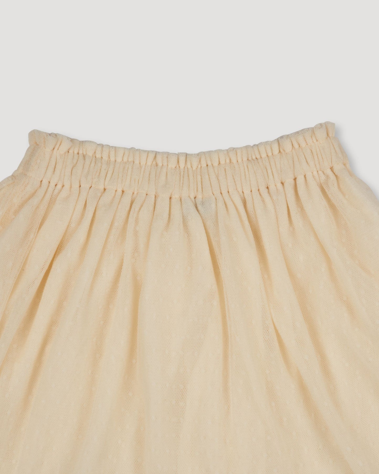 Early Sunday, Luna Skirt in Hazelnut Cream, made from Dyed Nylon Mesh Dobby fabric, featuring Elegant flow and gentle movement for everyday magic, shown in a closeup flat-lay view