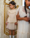 Early Sunday, Luna Skirt in Hazelnut Cream, made from Dyed Nylon Mesh Dobby fabric, featuring Elegant flow and gentle movement for everyday magic, shown in a front view of a model wearing it in a studio setting