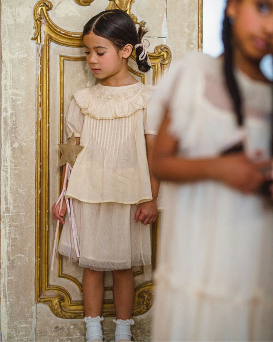 Early Sunday, Luna Skirt in Hazelnut Cream, made from Dyed Nylon Mesh Dobby fabric, featuring Elegant flow and gentle movement for everyday magic, shown in a front view of a model wearing it in a studio setting