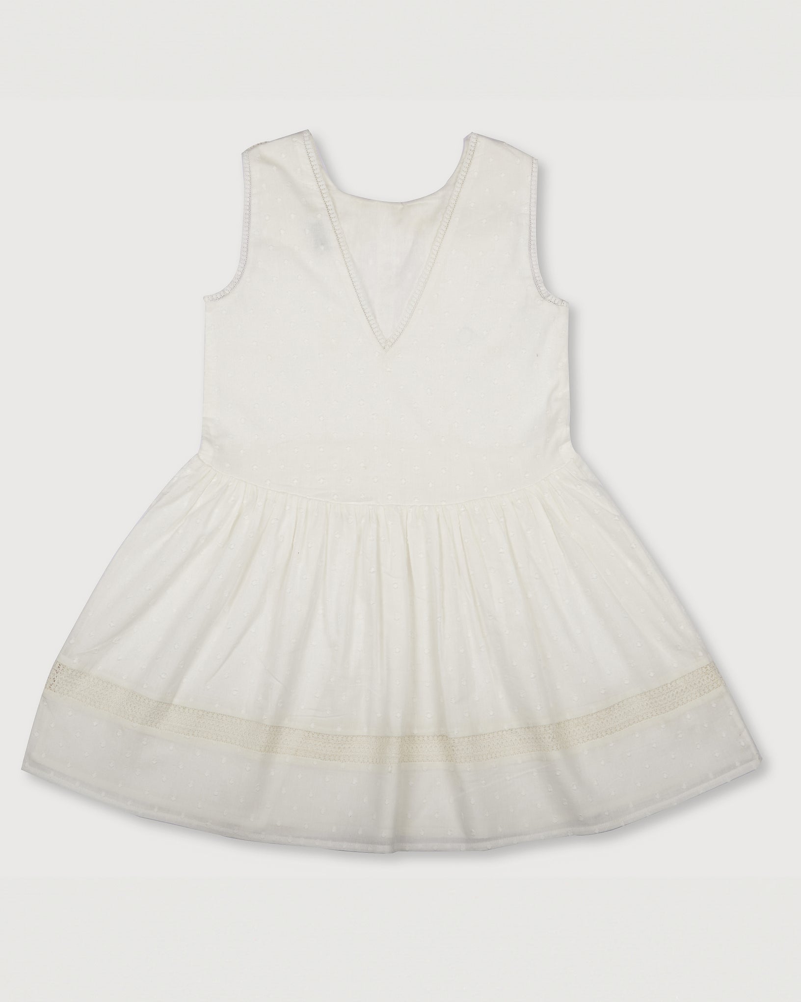Early Sunday, LYS Dress in Ivory color, made from Cotton Dobby Swiss Dots fabric, featuring flattering fit with delicate finishes, combining style and functionality for an effortlessly elegant look, shown in a back flat-lay view