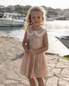 Early Sunday, LYS Dress in Garden Flowers print, made from Printed Cotton Cambric fabric, featuring flattering fit with delicate finishes, combining style and functionality for an effortlessly elegant look, shown in a front view of model wearing it