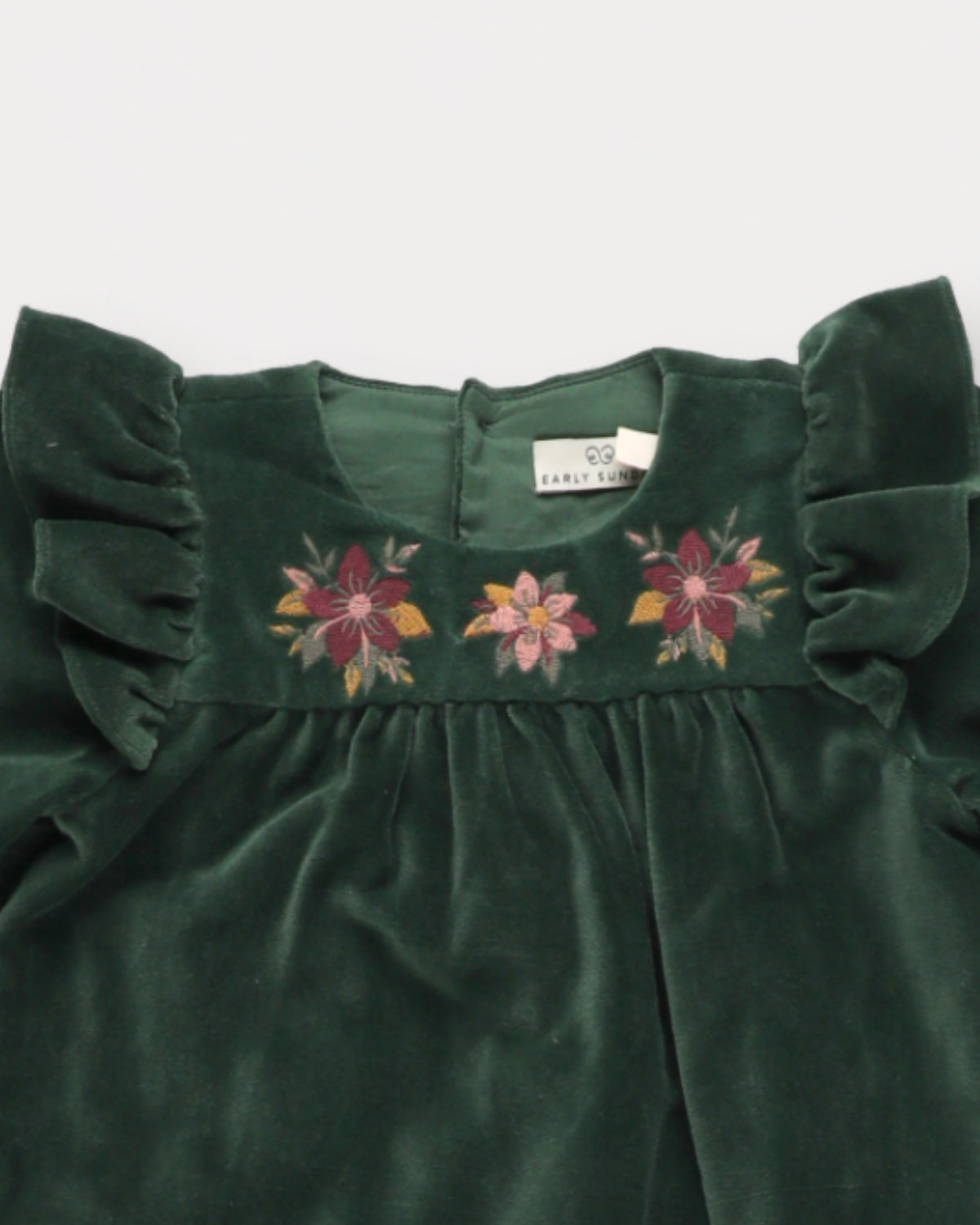Early Sunday, Maggie Baby Overall Romper in Forest Green, made from Cotton Velvet Velour's fabric, featuring a floral embroidery with frilled sleeves across shoulder, shown in a closeup flat-lay view