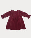 Early Sunday, Margot Dress in Plum, made from Cotton Double Gauze fabric, featuring classic silhouette with ruffle detailing around the sleeves, shown in a back flat-lay view