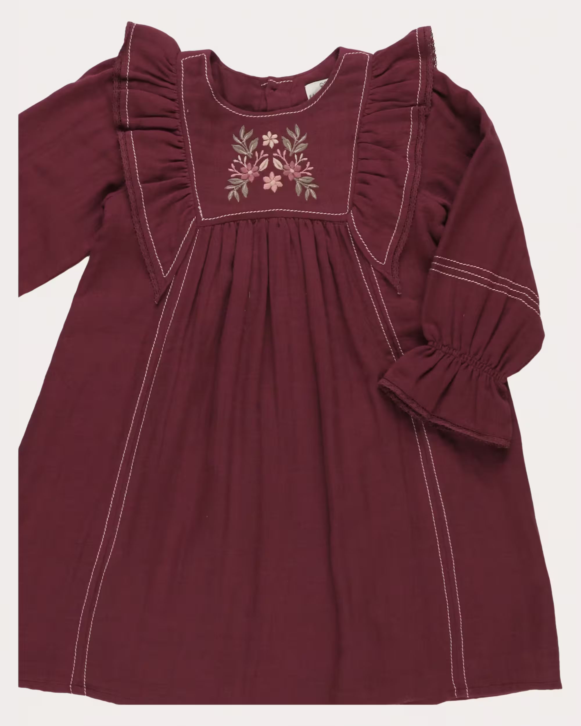 Early Sunday, Margot Dress in Plum, made from Cotton Double Gauze fabric, featuring classic silhouette with ruffle detailing around the sleeves, shown in a closeup flat-lay view