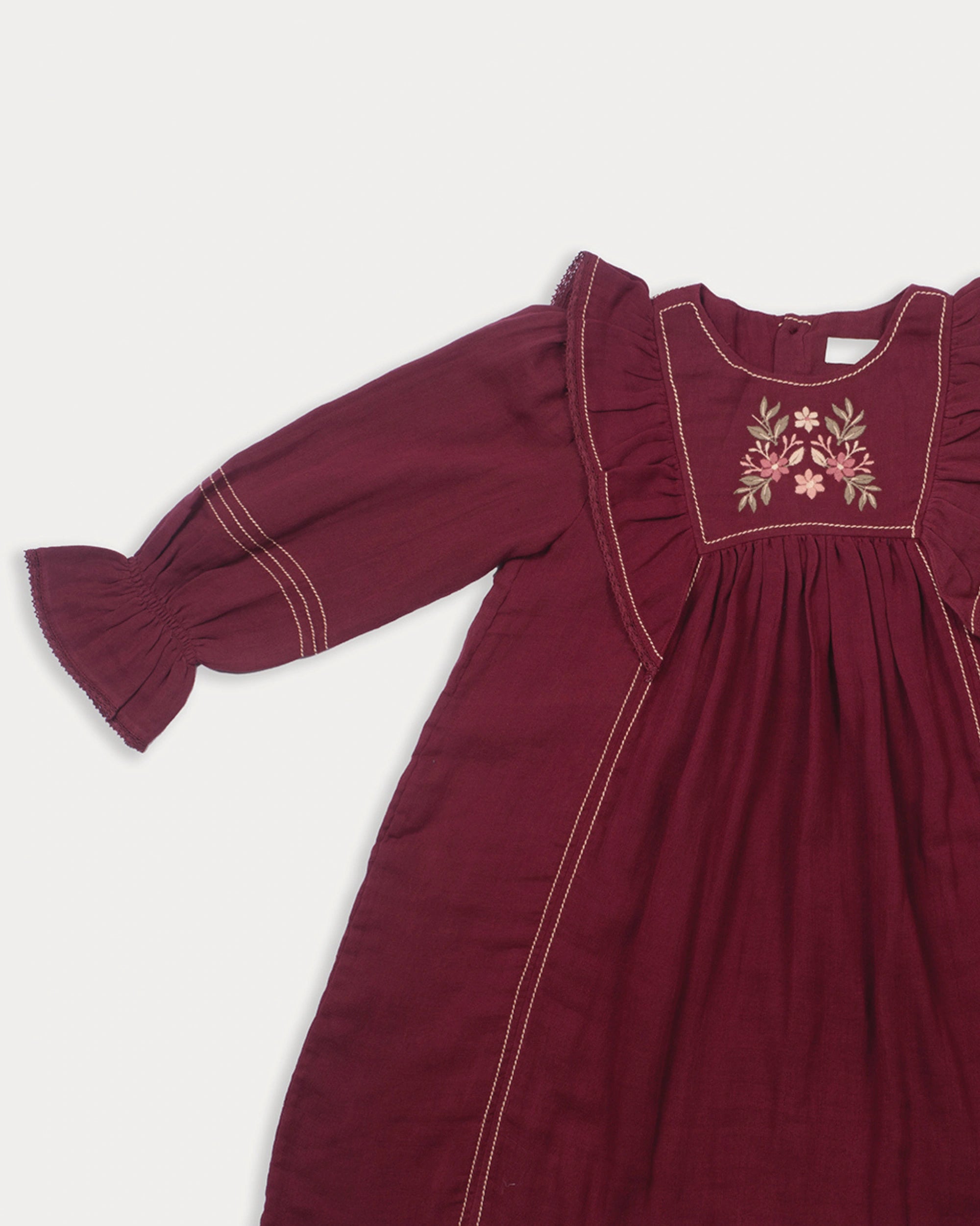 Early Sunday, Margot Dress in Plum, made from Cotton Double Gauze fabric, featuring classic silhouette with ruffle detailing around the sleeves, shown in a closeup flat-lay view