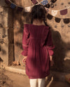 Early Sunday, Margot Dress in Plum, made from Cotton Double Gauze fabric, featuring classic silhouette with ruffle detailing around the sleeves, shown in a back view of model wearing it
