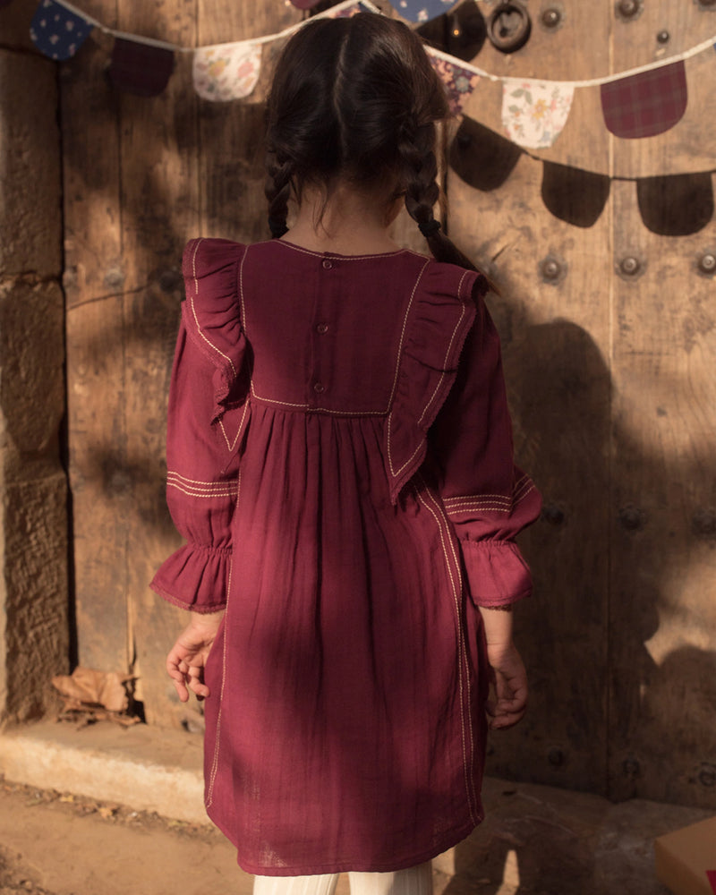 Early Sunday, Margot Dress in Plum, made from Cotton Double Gauze fabric, featuring classic silhouette with ruffle detailing around the sleeves, shown in a back view of model wearing it