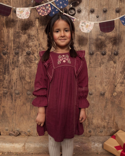 Early Sunday, Margot Dress in Plum, made from Cotton Double Gauze fabric, featuring classic silhouette with ruffle detailing around the sleeves, shown in a front view of model wearing it