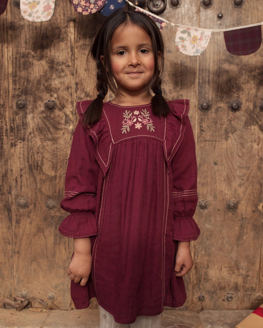 Early Sunday, Margot Dress in Plum, made from Cotton Double Gauze fabric, featuring classic silhouette with ruffle detailing around the sleeves, shown in a front view of model wearing it