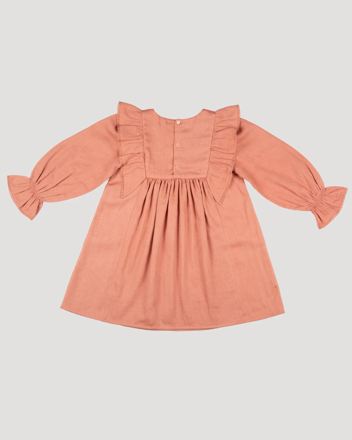 Early Sunday, Margot Dress in Earthy Pink, made from Cotton Satin fabric, featuring classic silhouette with floral embroidery around the yoke and ruffle detailing, shown in a back flat-lay view