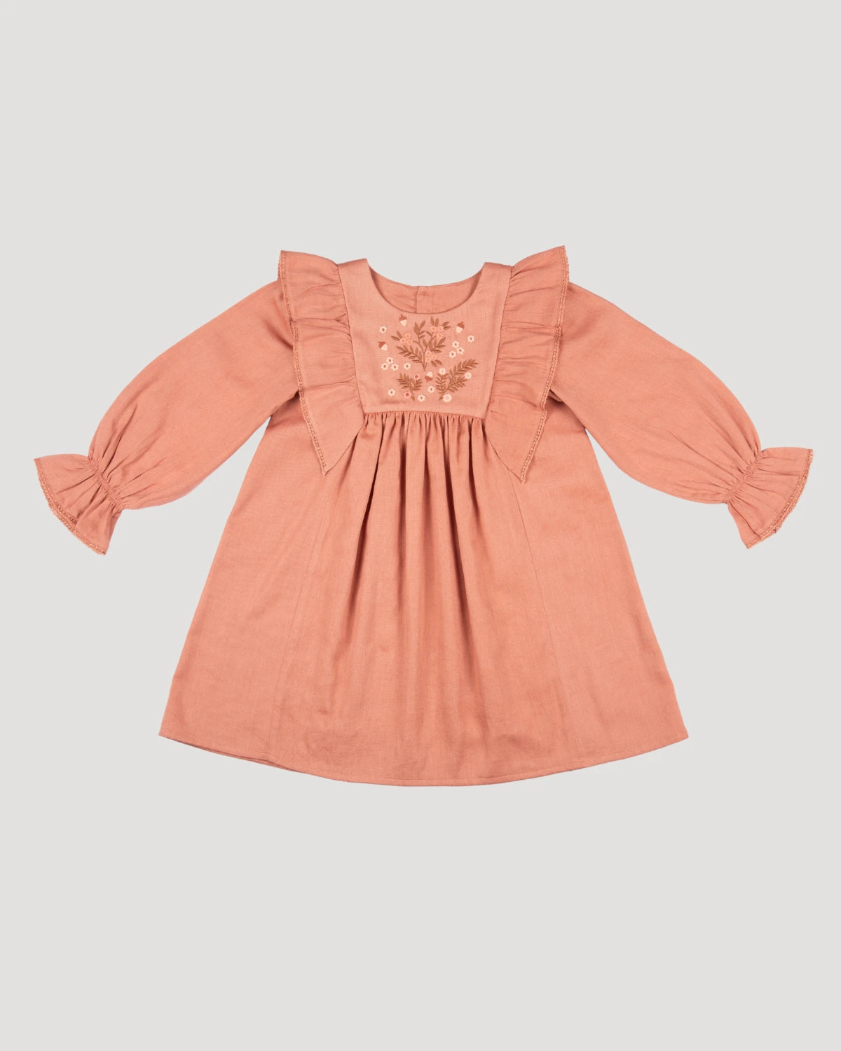 Early Sunday, Margot Dress in Earthy Pink, made from Cotton Satin fabric, featuring classic silhouette with floral embroidery around the yoke and ruffle detailing, shown in a front flat-lay view