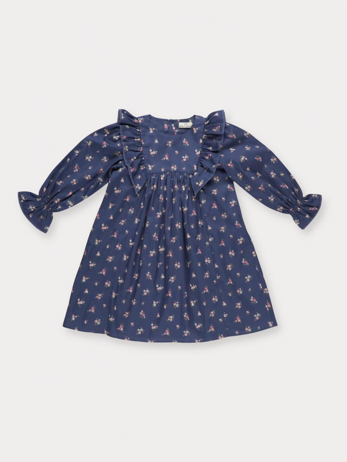 Early Sunday, Margot Dress in Ditsy Bouquet Navy, made from Printed Cotton Satin fabric, featuring classic silhouette with ruffle detailing around the sleeves, shown in a front flat-lay view