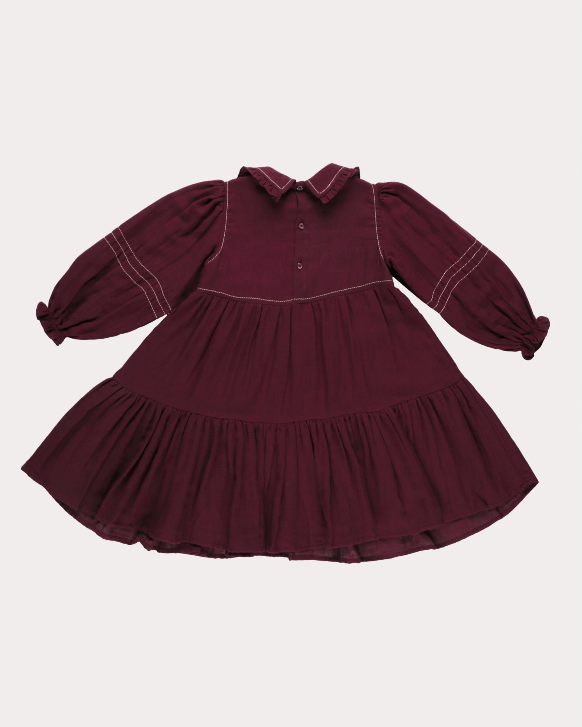Early Sunday, Marguerite Dress in Plum, made from Cotton Double Gauze fabric, featuring floral embroidery with frilled Peter Pan collar, shown in a back flat-lay view