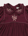 Early Sunday, Marguerite Dress in Plum, made from Cotton Double Gauze fabric, featuring floral embroidery with frilled Peter Pan collar, shown in a closeup flat-lay view