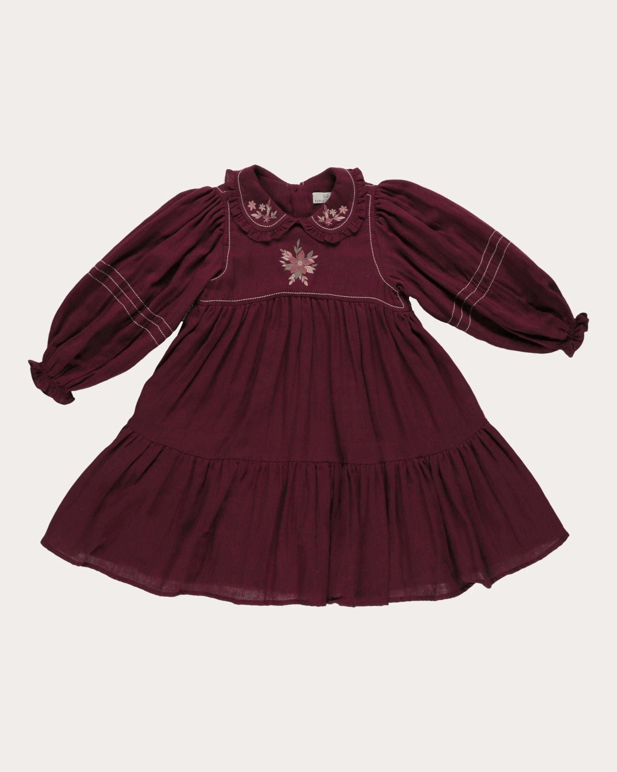 Early Sunday, Marguerite Dress in Plum, made from Cotton Double Gauze fabric, featuring floral embroidery with frilled Peter Pan collar, shown in a front flat-lay view