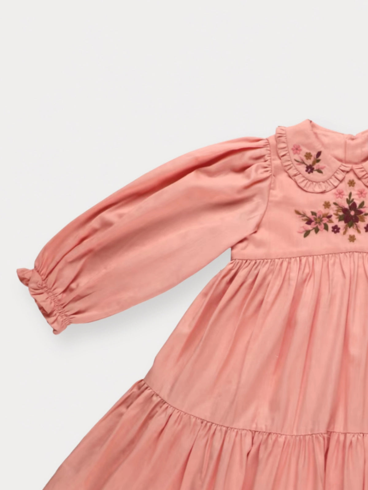 Early Sunday, Marguerite Dress in Blush Pink, made from Cotton Satin fabric, featuring floral embroidery with frilled Peter Pan collar, shown in a closeup flat-lay view