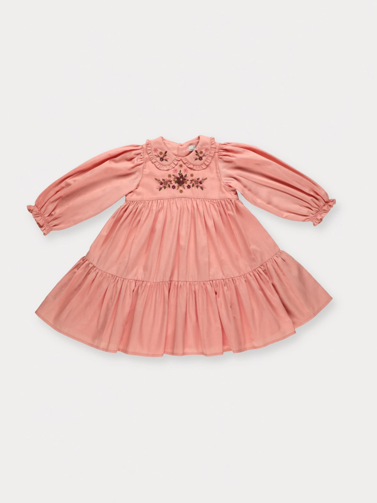 Early Sunday, Marguerite Dress in Blush Pink, made from Cotton Satin fabric, featuring floral embroidery with frilled Peter Pan collar, shown in a front flat-lay view