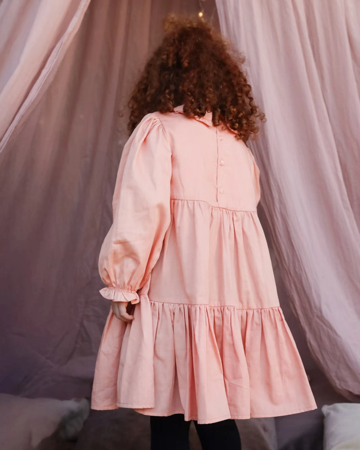 Early Sunday, Marguerite Dress in Blush Pink, made from Cotton Satin fabric, featuring floral embroidery with frilled Peter Pan collar, shown in a back view of model wearing it