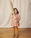 Early Sunday, Marguerite Dress in Acorn Dusty Pink, made from Printed Cotton Double Gauze fabric, featuring classic silhouette with a collar and ruffle detailing, shown in a front view of model wearing it