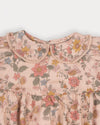 Early Sunday, Mathilda Baby Bubble Romper in Bloom, made from Printed Viscose Twill fabric, featuring a frilly peter pan collar with gathered sleeves, shown in a closeup flat-lay view