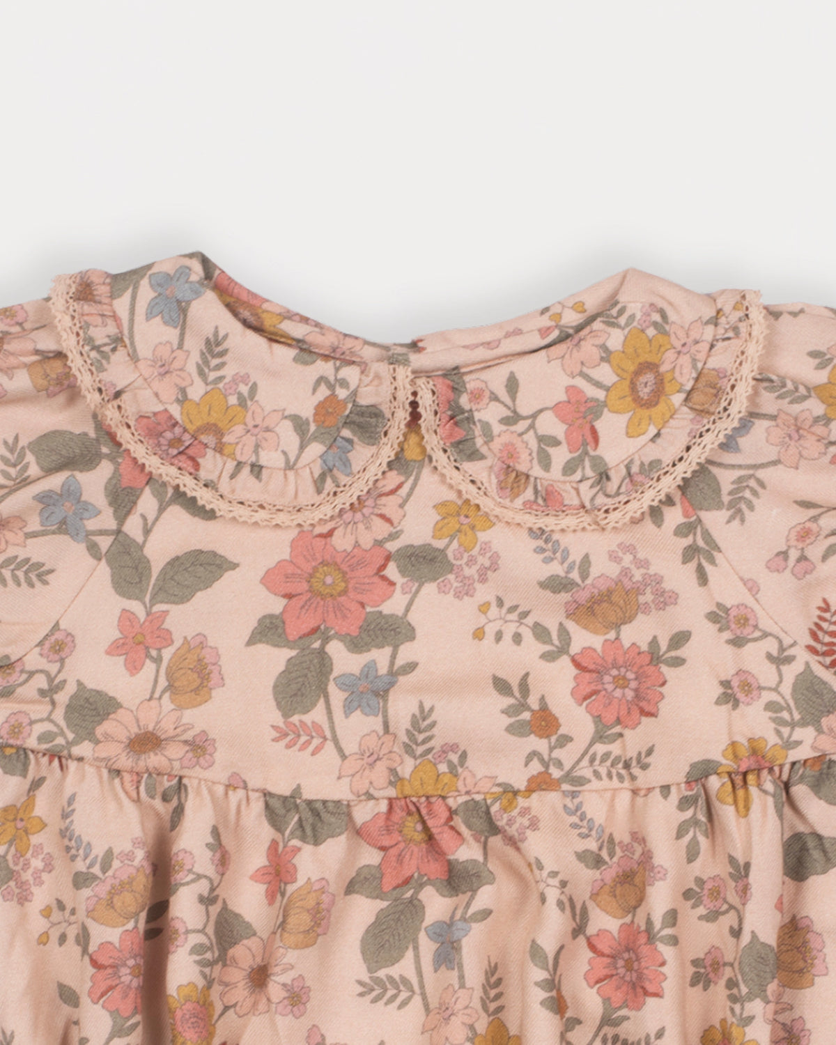 Early Sunday, Mathilda Baby Bubble Romper in Bloom, made from Printed Viscose Twill fabric, featuring a frilly peter pan collar with gathered sleeves, shown in a closeup flat-lay view