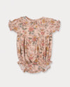Early Sunday, Mathilda Baby Bubble Romper in Bloom, made from Printed Viscose Twill fabric, featuring a frilly peter pan collar with gathered sleeves, shown in a front flat-lay view