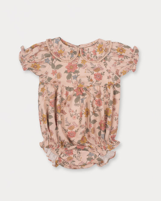 Early Sunday, Mathilda Baby Bubble Romper in Bloom, made from Printed Viscose Twill fabric, featuring a frilly peter pan collar with gathered sleeves, shown in a front flat-lay view