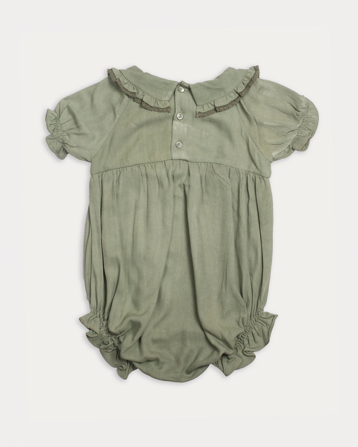 Early Sunday, Mathilda Baby Bubble Romper in Sage Green, made from Viscose Twill fabric, featuring a floral embroidery on a frilly peter pan collar, shown in a back flat-lay view