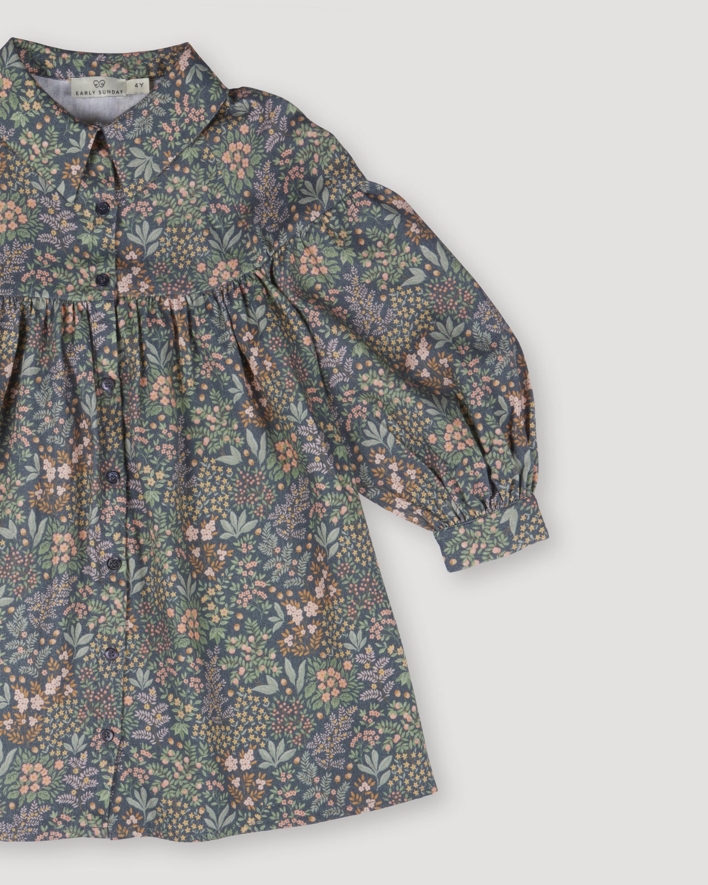Early Sunday, Melanie Dress in Autumn Garden Greyish Blue, made from Printed Cotton Satin fabric, featuring classic silhouette with a collar, shown in a closeup flat-lay view