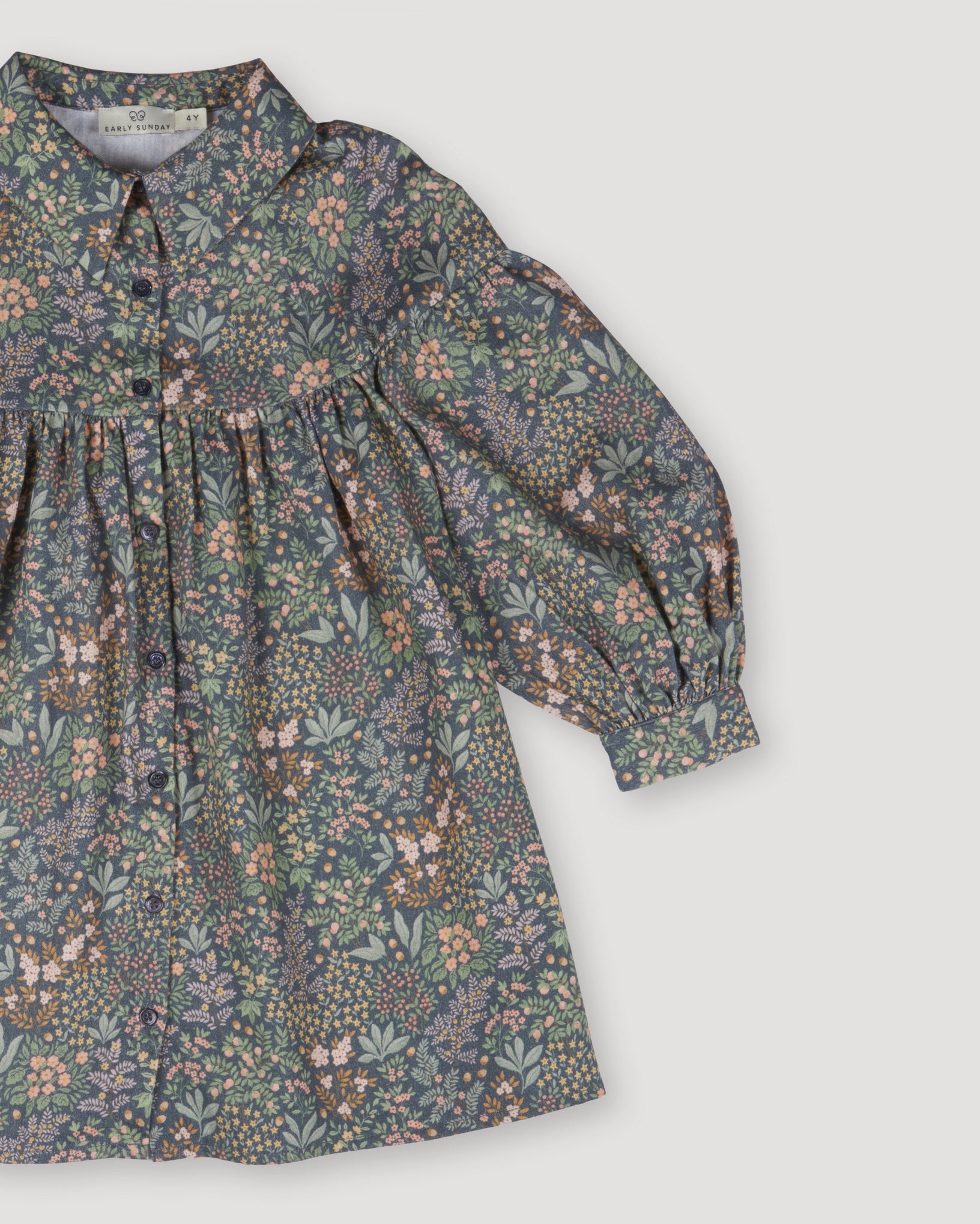 Early Sunday, Melanie Dress in Autumn Garden Greyish Blue, made from Printed Cotton Satin fabric, featuring classic silhouette with a collar, shown in a closeup flat-lay view