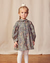Early Sunday, Melanie Dress in Autumn Garden Greyish Blue, made from Printed Cotton Satin fabric, featuring classic silhouette with a collar, shown in a front view of a model wearing it in a studio setting