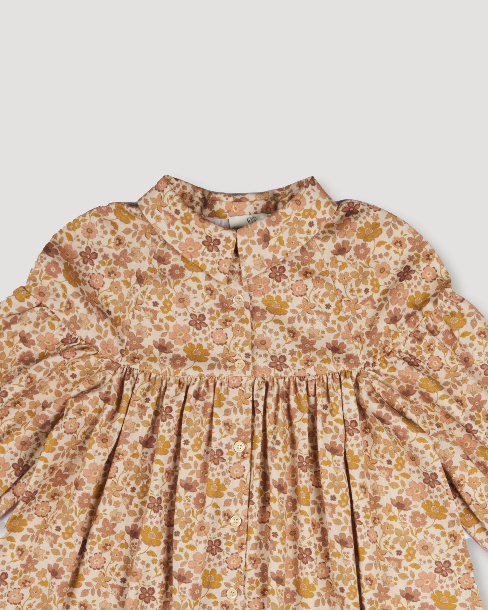 Early Sunday, Melanie Dress in Garden Flowers Dusty Pink, made from Printed Cotton Satin fabric, featuring classic silhouette with a collar, shown in a closeup flat-lay view