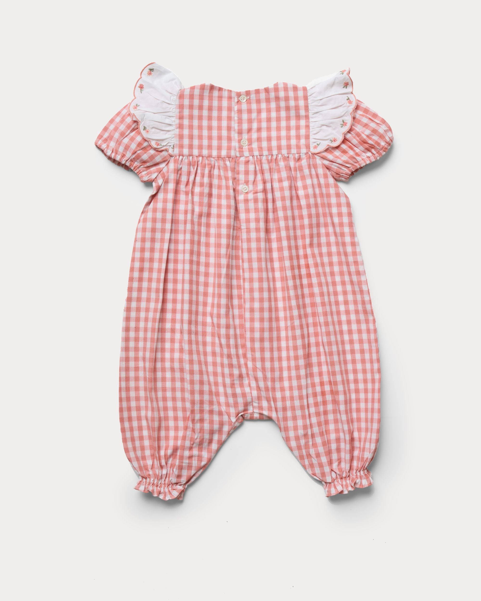 Early Sunday, Mia Baby Romper in Peony color, made from 100% Cotton Gingham Check fabric, featuring ruffled sleeves with rose embroidery, shown in a back flat-lay view