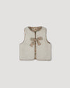 Early Sunday, Milly Baby Quilted Gilet (Reversible) in Garden Flowers print, made from Printed Cotton Cambric fabric, featuring reversible design for versatile styling, shown in a front flat-lay view