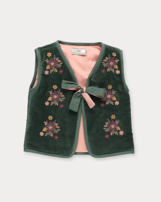 Early Sunday, Milly Baby Quilted Gilet in Forest Green, made from Cotton Velvet Velour's fabric, featuring a floral embroidery with a bow tie, shown in a front flat-lay view